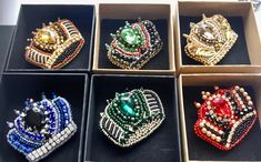 six different types of brooches are in a box together, each with its own jeweled crown