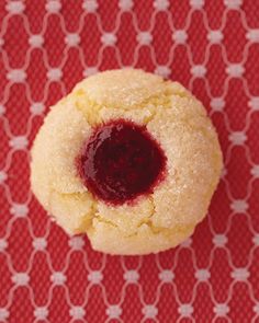 a close up of a cookie on a red table cloth with a white polka dot pattern