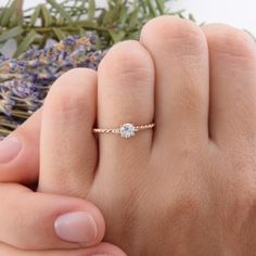 a close up of a person's hand with a ring on top of it