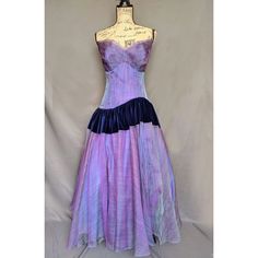 "Gorgeous vintage strapless Baumelle gown. Iridescent purple with navy blue-rich velvet trim at hips. Bodice in perfect condition with some minor discoloration inside lining but not visible on the outside. It's really just a beautiful gown. Hollywood glamour!! In the photo, the dress is a bit small for the bust form but the zipper is in perfect condition. Bust 32\" Waist 27\" Tip of corset to hem 47\"" Purple Ball Gown With Fitted Bodice, Purple Ball Gown Evening Dress, Blue Satin Evening Corset Dress, Fitted Purple Corset Dress For Prom, Purple Evening Dress With Corset Back, Purple Strapless Fitted Corset Dress, Purple Corset Dress With Fitted Bodice For Prom, Blue Corset Dress With Boned Bodice For Formal Occasions, Purple Sleeveless Corset Dress For Evening