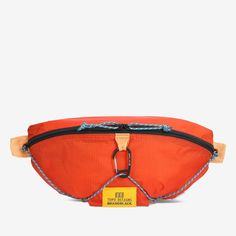 an orange fanny bag with a yellow tag on the front and blue trim around it