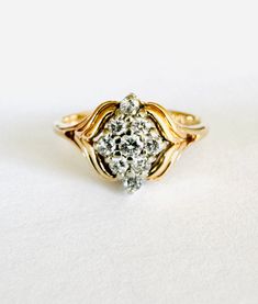 a diamond ring sitting on top of a white surface