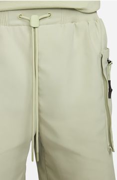 These structured twill shorts are engineered for adventure and comfort with a loose fit, drawcord waistband and side zip pockets to keep your essentials secure. 7 3/4" inseam; 27" leg opening; 13" front rise; 16" back rise (size Medium) 100% polyester Machine wash, tumble dry Imported Nordstrom x Nike: A curated lifestyle destination where fashion is the ultimate sport Nylon Athleisure Cargo Shorts, Nylon Athleisure Shorts With Cargo Pockets, Urban Outdoor Shorts With Side Pockets, Urban Shorts With Side Pockets For Outdoor, Utility Shorts With Drawstring For Streetwear, Utility Drawstring Shorts For Streetwear, Utility Style Drawstring Shorts For Streetwear, Urban Style Shorts With Side Pockets For Outdoor, Techwear Cargo Shorts For Hiking