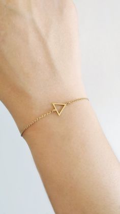 14K 9K Delicate Triangle Charm Bracelet, Geometric gold bracelet, Dainty Minimalist gold chain bracelet, Gift for Daughter, Birthday Gift, FREE EXPRESS SHIPPING Beautiful and delicate bracelet with a triangle frame charm made in 14K or 9K solid gold. Whsiper...I love Geometry! -------------------------------------------------- D E T A I L S 14K Solid Gold or 9K Solid Gold Dimensions: 10mmx10mm Soldered chain and jump rings with a spring clasp closure --------------------------------------------- Minimalist Yellow Gold Hypoallergenic Bracelets, Minimalist Hypoallergenic Yellow Gold Bracelets, Minimalist Gold Hypoallergenic Chain Bracelet, Minimalist Delicate Chain Bracelet As Gift, Minimalist Delicate Chain Bracelet For Gift, Minimalist Hypoallergenic Gold Bracelet As Gift, Minimalist Hypoallergenic Gold Bracelet Gift, Minimalist Hypoallergenic Yellow Gold Bracelet, Gold Minimalist Chain Bracelet As Gift