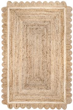 a beige rug with scalloped edges