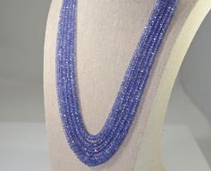 Tanzanite five strand necklace of faceted graduated rondelles with an adjustable silk cord.  Well matched , beautifully faceted, natural tanzanite fine quality beads. Tanzanite is a birthstone for December and the 24th wedding anniversary gemstone. Natural tanzanite from Tanzania 469 carats graduating from 3 to 7.5 mm The closure is an adjustable silk cord with tassels The length of the shortest strand is 18 inches and the longest is 21 inches Jewelry from Stowe Gems arrives beautifully packaged Tanzanite Beads Jewelry Indian, 24th Wedding Anniversary, Stowe Vt, Australian Opal Ring, Garnet And Diamond Ring, Tanzanite Necklace, Tanzanite Jewelry, White Gold Earrings Studs, White Gold Studs