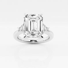 an emerald cut diamond ring with baguets on the shoulders