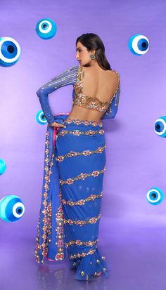 A classic studded pre-stitched blue saree in georgette and tulle bottom embellished with reflective acrylics, pearls, sequins, and glass cut crystals. Paired with a full sleeve blouse embellished in metal pieces, pearls, and crystals.From Papa Don't Preach's Nazar Na Lage collection. DELIVERY TIMEPlease allow 8-12 weeks for your outfit to arrive. FABRIC DETAILSGeorgette, Tulle Professional cleaning only. Traditional Blue Pre-draped Saree For Party, Blue Traditional Pre-draped Saree For Party, Semi-stitched Embellished Blue Blouse Piece, Blue Pre-draped Saree For Festive Evenings, Glamorous Blue Sets For Festive Occasions, Glamorous Blue Festive Sets, Blue Bollywood Pre-draped Saree For Evening, Semi-stitched Embellished Blue Saree, Blue Party Wear Choli With Traditional Drape