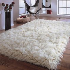 a large white rug in a living room