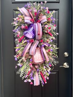 a purple and pink wreath on the front door