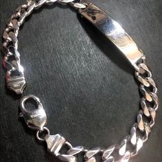 New Thick Heavy Solid 925 Silver Italian Curb Id Link Chain Bracelet Style : Thick Curb Id Link Bracelet Metal Type : 14k White Layer On Solid .925 Sterling Silver Approx. Length : 9.5" Inches Approx. Width : 0.31" Inches ( 8.0 Mm ) Approx. Thickest : 0.11" Inches ( 2.9 Mm ) Approx. Weight : 27 Grams To 28 Grams Region Imported From: Italy Clasp : Lobster Clasp Item # : Jn10161712-Shop-912-Bb December Jewelry, Italian Bracelet, Bracelet Metal, Link Chain Bracelet, Bracelet Style, Metal Bracelets, Chain Link Bracelet, Silver Bracelets, Solid 925 Sterling Silver