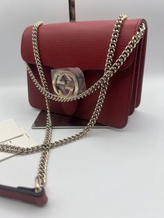 Gucci GG Dollar Calf Red Interlocking Chain Handbag Leather Bag Italy 510304. Gucci Gucci GG Dollar Calf Red Interlocking Chain Handbag Leather Bag Made in Italy NEW Dustbag Shoulder Bag Italy Authentic New New with Tags. Made in Italy. ONLY 1 in stock Red bags are so very in this season!!! Approx Base Length: 7.5” Height: 5.5” Width: 3.5” Shoulder Drop: 11” and 22.25” Can be worn as a shoulder bag or a crossbody. Dollar Calfskin Medium Interlocking G Shoulder Bag A Gucci handbag can be instantly-recognized anywhere, any time. Thanks to the brand’s pioneering Creative Director, the Florentine fashion house has become one of the world’s most influential names. This red leather GG ring shoulder bag from Gucci features gold-tone hardware, an adjustable shoulder strap, a hanging Double G ring Elegant Red Bags With Lock, Luxury Red Bag With Lock, Luxury Chain Crossbody Bag, Luxury Shoulder Bag With Chain As Gift, Gucci Leather Bags With Lock, Luxury Bags With Chain Strap For Gift, Luxury Bags With Chain Strap As Gift, Luxury Bag With Chain Strap As Gift, Luxury Chain Bags As Gift