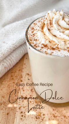 a close up of a cup of coffee with whipped cream on top and the words easy coffee recipe cinnamon spice latte