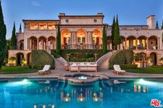 a large house with a pool in front of it