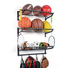 a rack with sports balls, gloves and tennis racquets