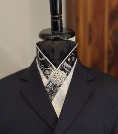 White faux silk pre-tied tie has choice of three color combinations: A) Black and silver metallic trim, silver piping, black satin center knot with silver-tone rhinestone brooch.  B) Silver metallic trim with grey satin piping and center knot, rhinestone button.  C) Sunflower yellow brocade trim with navy satin piping and center knot, blue gem button. Classic Ribbon Suit And Tie Accessories For Formal Occasions, Classic Formal Suit Accessories With Ribbon, Elegant Satin Neckwear For Formal Occasions, Elegant Adjustable Silver Suit And Tie Accessories, Formal Fitted Ties With Ribbon Details, Elegant Fitted Silver Suit And Tie Accessories, Grey Brocade Suit, Classic Fitted Silver Suit And Tie Accessories, Adjustable Silver Suit And Tie Accessories For Black Tie