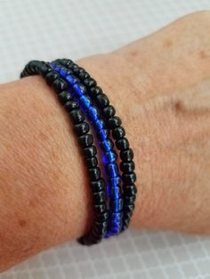 Handmade set of 3 thin blue line bracelets with black and blue glass beads on a stretchy bracelet. Show your support for the police with our 3 individual seed bead bracelets.  Bracelets are made with 6.0 see beads.  You get two black and one blue (to wear in the middle). Wear these bracelets proudly. Grey Beads, Black Bracelets, Beaded Choker Necklace, Bead Charm Bracelet, Stretchy Bracelets, Glass Beaded Bracelets, Bead Bracelets, Seed Bead Bracelets, Colorful Bracelets