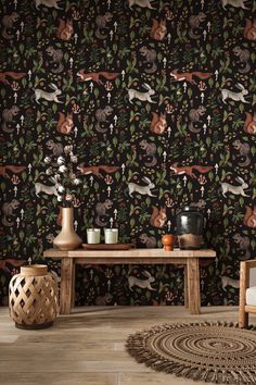 an animal themed wallpaper with deers and other animals on the wall next to a wooden table