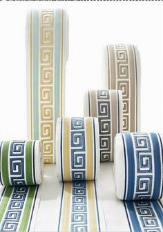 four rolls of decorative tape with greek designs on them