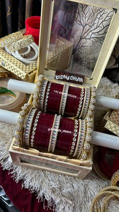 several bracelets are in a wooden box on a table