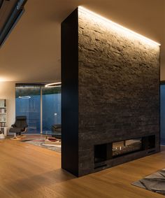 a living room filled with furniture and a fire place next to a wall mounted tv