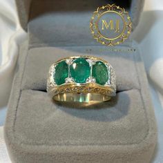 Ring Details - Natural Emeralds - Main Stone Size: 7.00x5.00 mm Approximate - Ring Front width: 13.5 mm - Band Width: 5.8 mm - Band Thickness: 2.00 mm - 1.00mm Cubic Zirconia in Setting - Rhodium Coated - Gold Plated - Gross Weight: 17.00 grams - Handmade Ring - Hand Engraved Design - Sterling Silver 925 (Hallmark) - Dimensions and Weight Depends on Variations in Sizes. - Available in all Sizes ( Please make sure about your ring sizes) - DM for Customizations NOTE: - Our Products are Made to Ord Luxury Hallmarked Emerald Gemstones, Luxury Multi-stone Emerald Ring, Luxury Emerald Gemstones With Accent Stones, Luxury Multi-stone Emerald Ring In White Gold, Luxury White Gold Multi-stone Emerald Ring, Luxury Emerald Rings Hallmarked, Luxury Emerald Rings With Accent Stones, Luxury Gemstone Ring, Luxury Multi-stone Emerald Jewelry