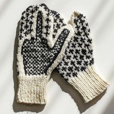 a pair of black and white knitted gloves