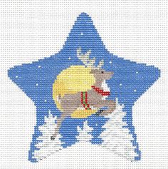 a cross stitch christmas ornament with a reindeer on it's back and snow covered ground