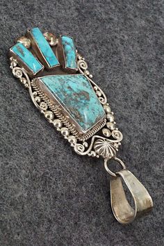 This vintage Morenci turquoise and sterling silver pendant was made by Navajo silversmith Oliver Smith. The back is signed O. Smith and stamped .925. The silver retains an aged patina.Length: 3 3/8"Width: 1 3/8"Free shipping on all orders! We ship with USPS and always include tracking. All orders ship within a day of payment.Returns are accepted up to 30 days after you receive your order. Just send us a message. Our shop offers cash back or store credit. The item must be returned in new conditio Vintage Silver Turquoise Necklace With Patina, Vintage Sterling Silver Turquoise Necklace With Patina, Vintage Turquoise Pendant Necklace With Patina, Vintage Blue Turquoise Necklace With Concho, Vintage Turquoise Necklace With Concho Detail, Vintage Turquoise Concho Necklace In Sterling Silver, Vintage Sterling Silver Concho Turquoise Necklace, Vintage Sterling Silver Turquoise Concho Necklace, Oliver Smith