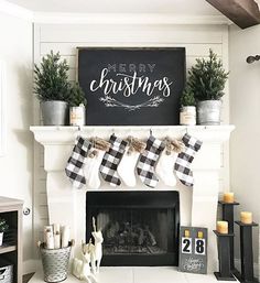 a fireplace with stockings hanging from it's mantle and christmas decorations on the mantel