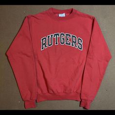 This Vintage Champion Sweatshirt Is A Must-Have For Any Rutgers University Fan. The Red Knit Cotton Blend Fabric Is Accented With The Iconic Rutgers Logo, Making It A Perfect Addition To Any 90s-Themed Outfit. The Sweatshirt Features A Classic Fit, Long Sleeves, And A Pullover Closure With A Crew Neck Neckline. The Sweatshirt Is Made With Breathable Materials, Making It Suitable For All Seasons. It's Great For Gym And Training Activities, As Well As Walking And Basketball. This Unisex Sweatshirt Retro Red Top With Ribbed Cuffs, Vintage Red Tops With Ribbed Cuffs, Vintage Red Top With Ribbed Cuffs, Retro Red Cotton Sweatshirt, Red Retro Cotton Sweatshirt, 90s Themed Outfits, Vintage Gym, Training Activities, Rutgers University