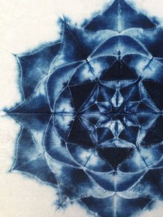 a blue and white tie - dyed artwork with an intricate design