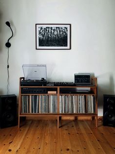 a record player sitting on top of a wooden shelf