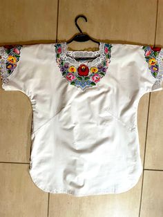 A Unique Handmade white blouse embroidered with authentic Hungarian Kalocsa pattern. A beautiful Hungarian Traditional Handmade Blouse. It was hand embroidered lately by  a unique Hungarian craftswoman. This Hungarian blouse is unique and only, because there is no two identical pieces of handwork. This blouse is an amazing embroidered outfit suitable for many occasions. It can be a gift for mom, sister, wife daughter or the loved ones. It can be a fall outfit for ladies both for a special occasi Traditional Spring Blouse With Machine Embroidery, Traditional White Embroidered Top, White Machine Embroidered Blouse For Spring, Traditional White Top With Intricate Embroidery, Folk Style Fitted White Embroidered Top, White Embroidered Blouse For Spring, Fitted Folk White Top, White Fitted Folk Top, White Fitted Folk Style Top