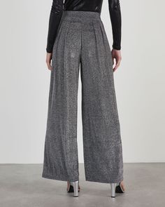 Introducing: your new favorite trousers! The Meet And Greet Lurex Knit Trouser Pants are perfect for when you want a bit of sparkle and shine but need to keep it professional and polished. Complete with front pleats and a flattering, wide-leg fit, we love this pair with solid, mock neck tops. High rise Fitted waist Front pleats Wide leg fit No pockets, closures or lining 70% Nylon 25% Lurex 5% Spandex Runs Small Chic Glitter Bottoms For Evening, Chic Glitter Bottoms For Fall, Fall Evening Glitter Pants, Glitter Wide-leg Evening Bottoms, Glitter Wide Leg Bottoms For Night Out, Glitter Wide-leg Bottoms For Night Out, Elegant Wide Leg Glitter Pants, Elegant Stretch Pleated Pants, Glamorous Wide Leg Glitter Pants