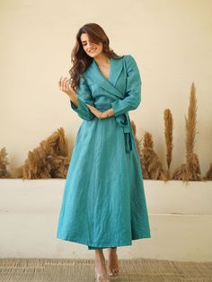 100% LINEN - LINEN WRAP DRESS WITH SHAWL COLLARS, FULL SLEEVES, Waist Tie & Concealed Pockets. Drape yourself in the tranquil, breezy elegance of our Teal Blue Linen Wrap Dress. Inspired by European sophistication, this long, linen maxi dress exudes a luxurious aura with its kimono-style robe silhouette. The shawl collars add a graceful touch, while the full sleeves and waist tie cinches your figure for a flattering ensemble that transitions effortlessly from breezy daywear to chic evening attir Blue Linen Long Sleeve Maxi Dress, Blue Linen Long Sleeve Midi Dress, Blue Long Sleeve Linen Midi Dress, Formal Long Sleeve Linen Dress, Elegant Long Sleeve Blue Linen Dress, Elegant Blue Long Sleeve Linen Dress, Blue Linen Long Sleeve Dress, Blue Long Sleeve Linen Dress, Linen Wrap Dress