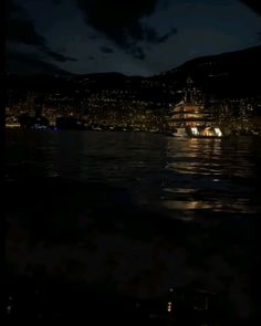 a large boat floating on top of a lake at night