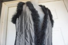 "Vintage long vest with feather trim. Unique ultra long style. In very good condition. Labeled size medium. Measurements taken across back laid flat 21\" across back armpit to armpit 20\" across front of waist 55\" length" Fitted Winter Vest With Faux Fur Trim, Studio 54 Party, Floral Vests, Long Vest, Vintage Vest, Feather Trim, Sequin Jacket, Long Vests, Sleeveless Jacket