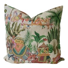 a decorative pillow with an image of people and animals on the front, surrounded by tropical plants