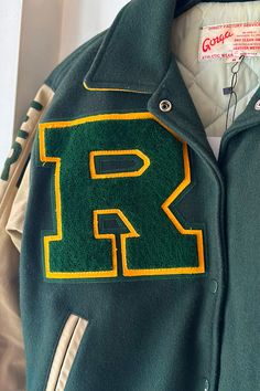 Classic varsity jacket from Red Bank Catholic high school in forest green felt with tan sleeves. Features embroidered chenille detailing of drama masks on back and "R" on front. Embroidered details include "Danielle" at front chest, "Tech Crew" on right arm, and "2007" on left arm. Snap front closure. Fits size S Excellent condition School In Forest, School Varsity Jacket, Tech Crew, Drama Masks, Catholic High School, Red Bank, Only Hearts, Accessories Bags Shoes, Catholic School