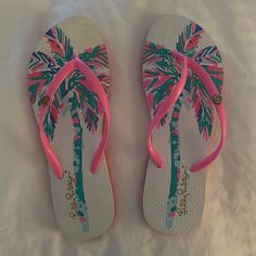 Brand: Lilly Pulitzer Color: Pink And Green Tropical Description: Tropical Printed Sandals Condition: Nwot Size: 7/8 From A Pet And Smoke Free Home! Cute Sandals For Beach Season Vacation, Fun Synthetic Flip Flops For Vacation, Fun Open Toe Flip Flops For Vacation, White Tropical Open Toe Flip Flops, White Tropical Open Toe Sandals, Fun Flat Flip Flops For Vacation, Fun White Flip Flops For Vacation, Cute Pink Flip Flops For Vacation, White Fun Flip Flops For Spring