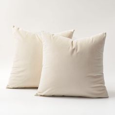 two white pillows sitting next to each other