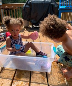 two children playing with toys on a deck