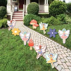 fairy garden decorations in front of a house