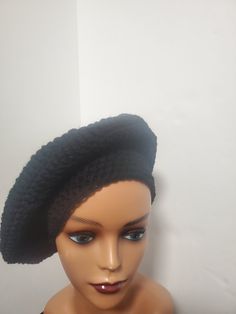 Add some color to your casual outfits with this handmade black crochet beret tam beanie. Made from lightweight and breathable acrylic material, this hat is perfect for all seasons. The beanie features accents of crochet and is adorned with a reggae-themed design that is sure to turn heads. This one-size-fits-all beanie is an ideal addition to your wardrobe if you are a fan of reggae or rastafarian culture. It has stretchy fabric that ensures a comfortable fit and is suitable for both men and women. With no tags attached, this beanie is like new and ready to be worn to any casual occasion. Black Acrylic Beanie, Black Acrylic Yarn Beanie Cap, Black Acrylic Yarn Beanie One Size, Black Acrylic Yarn Beanie, One Size Black Acrylic Yarn Beanie, Black One Size Beanie From Acrylic Yarn, Black One Size Beanie In Acrylic Yarn, Black One Size Acrylic Yarn Beanie, Casual Black Slouchy Crochet Hat