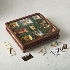 a game board sitting on top of a table next to some cards and other items