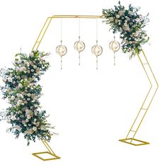 an arch decorated with white flowers and greenery for a wedding ceremony or party decoration