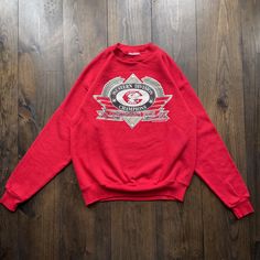 Vintage 1990 Cincinnati Reds Champions MLB American Baseball Crewneck Sweatshirt / made in USA/ tag size Medium Pit to Pit:    22" Length:    24" Sleeve:    30" Please check the measurements before purchasing  -------------------------------- ⚠️ Please Note: All of our items are vintage. Please note that with vintage clothing, items may show some signs of wear. We do our best to include as much information about the items condition as possible. Please look carefully through the photos and feel f Vintage Red Crew Neck Tops, Vintage Red T-shirt For Winter, Vintage Red Long Sleeve T-shirt, Retro Red Sweatshirt With Graphic Print, Retro Red Graphic Print Sweatshirt, Retro Red Sweatshirt For Streetwear, Vintage Red Long Sleeve Sweatshirt, Red Vintage Long Sleeve Sweatshirt, Vintage Red Cotton Sweatshirt