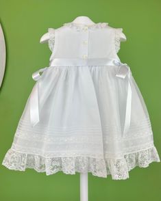 An elegant and delicate white dress for girls to wear on a special day. It is made with swiss organdi and laces. It has buttons on the back for closure. Made in Spain Inside: 65% polyester 35% cotton Dry Clean Final sale, no exchanges nor returns are accepted Lace Dress With Fitted Bodice For Dress-up, White Baptism Dress With Lace Bodice For Dress-up, Elegant Lace Trim Dress For Dress-up, Elegant Lace Trim Dress For Dress-up Occasions, Elegant Dresses With Lace Trim For Dress-up, Lace Dress With Lace Trim For Dress-up Occasions, Lace Dress With Fitted Bodice For First Communion, Baptism Dress With Lace Bodice And Organza Material, Baptism Dress With Lace Collar