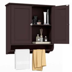 a bathroom cabinet with two towels hanging on the wall